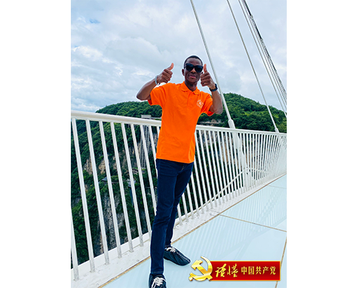 高翔站在张家界大峡谷玻璃桥上拍摄视频,用法语介绍张家界.png